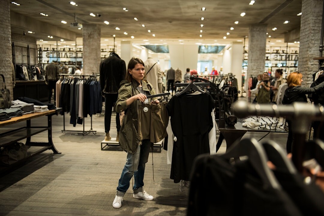 Personal shopper helping a client choose garments in a boutique