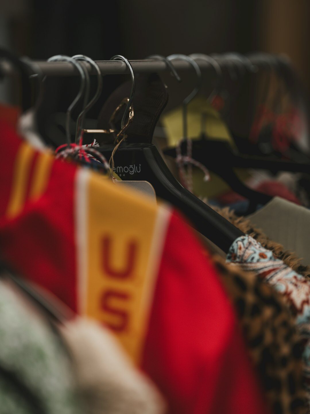 Fashion editor organizing garments on a wardrobe rail